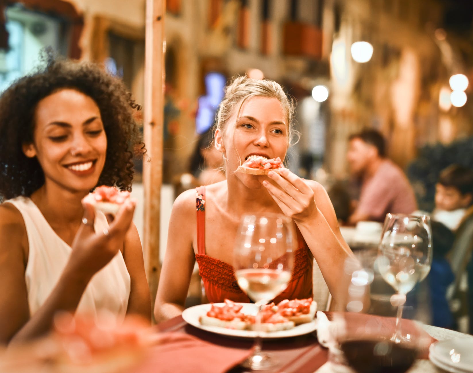 Women eating bruschetta together