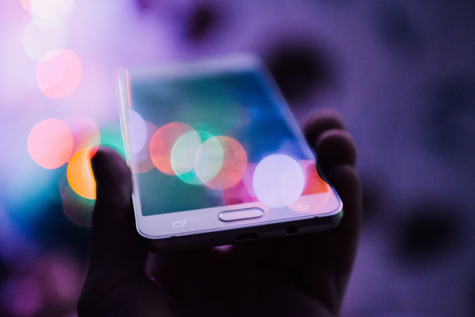 colorful photo of person holding iphone