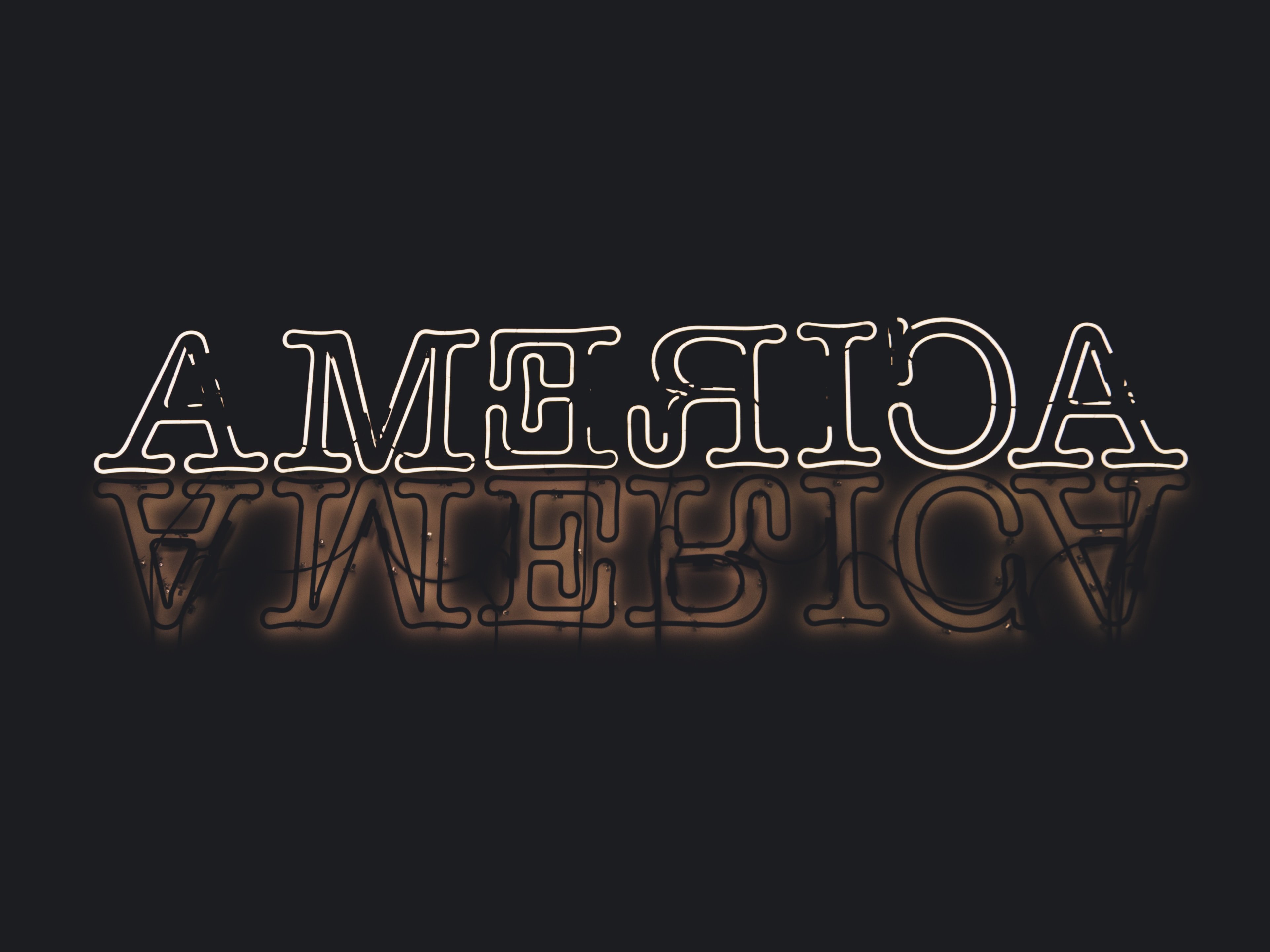 America neon sign against black backdrop?width=698&height=466&fit=crop&auto=webp&dpr=4