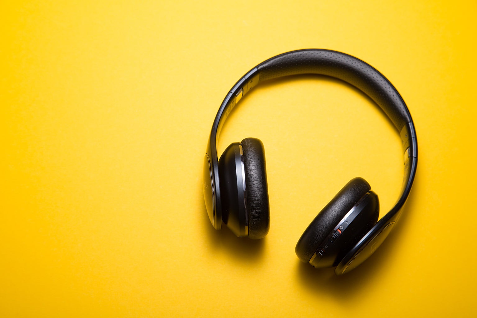 black headphones on a yellow background