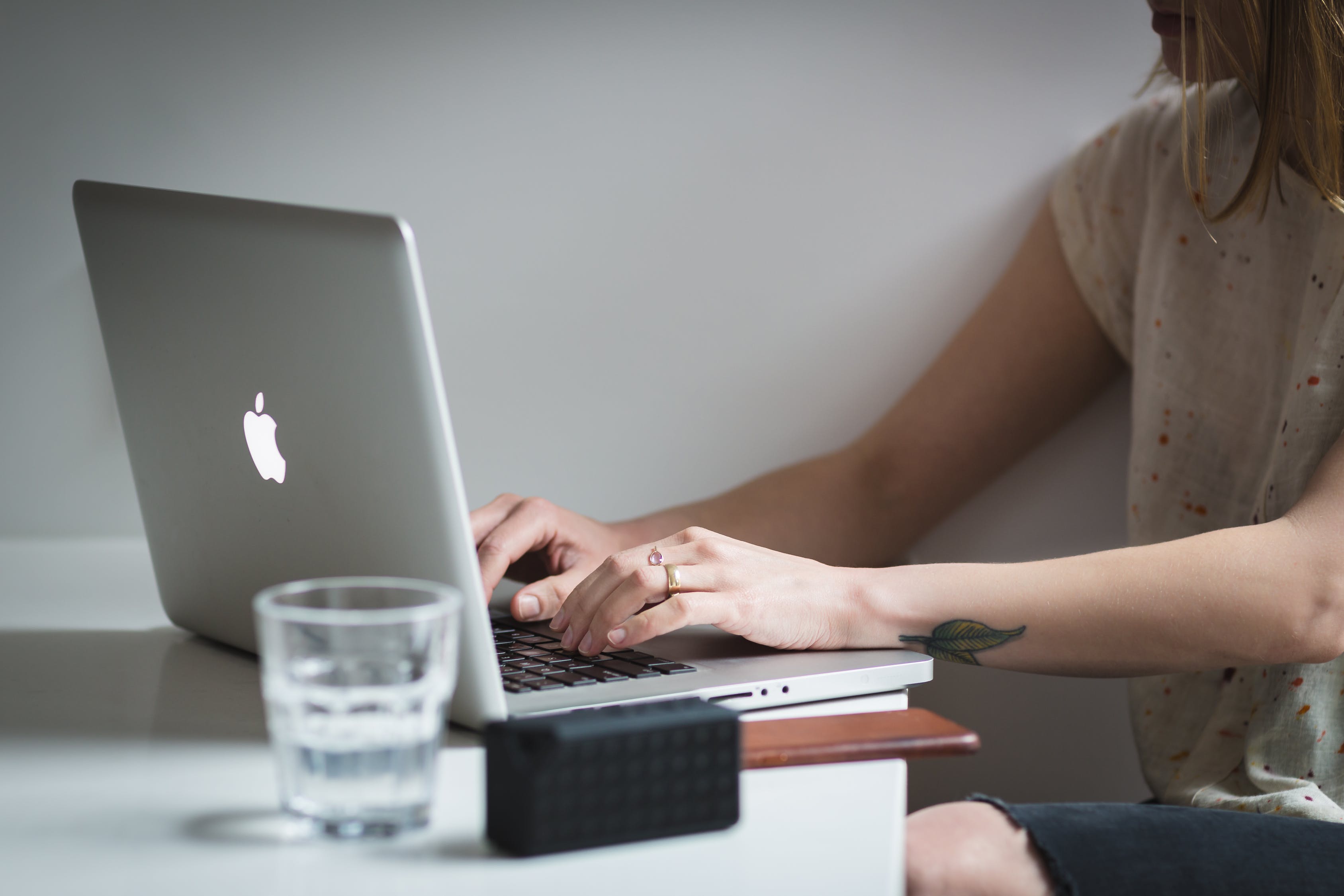 women typing on a laptop