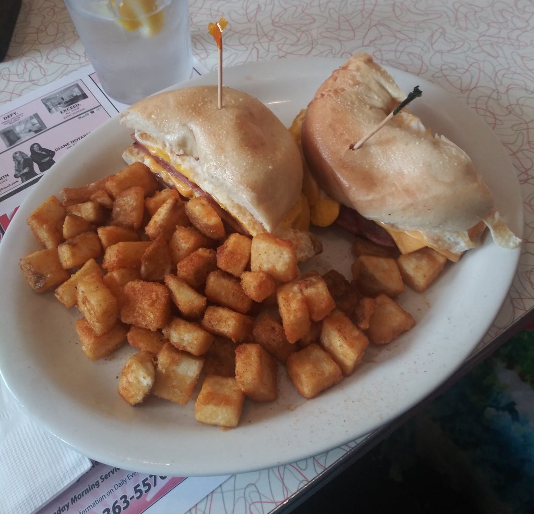 Porkroll Egg and Cheese Sandwich on a Plain Bagel with Breakfast Potatoes