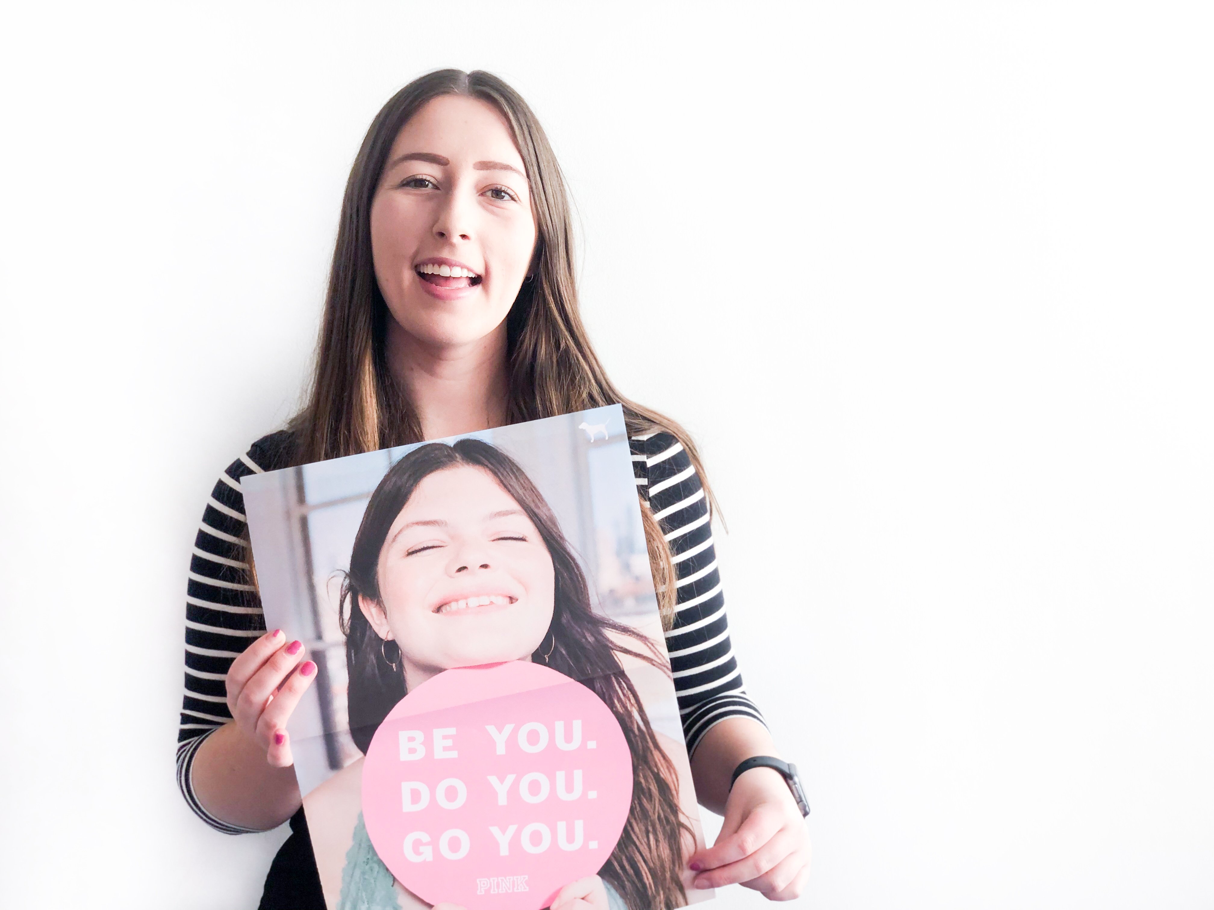 Photo of Kim Davison holding PINK GRL PWR poster to be used in an interview article