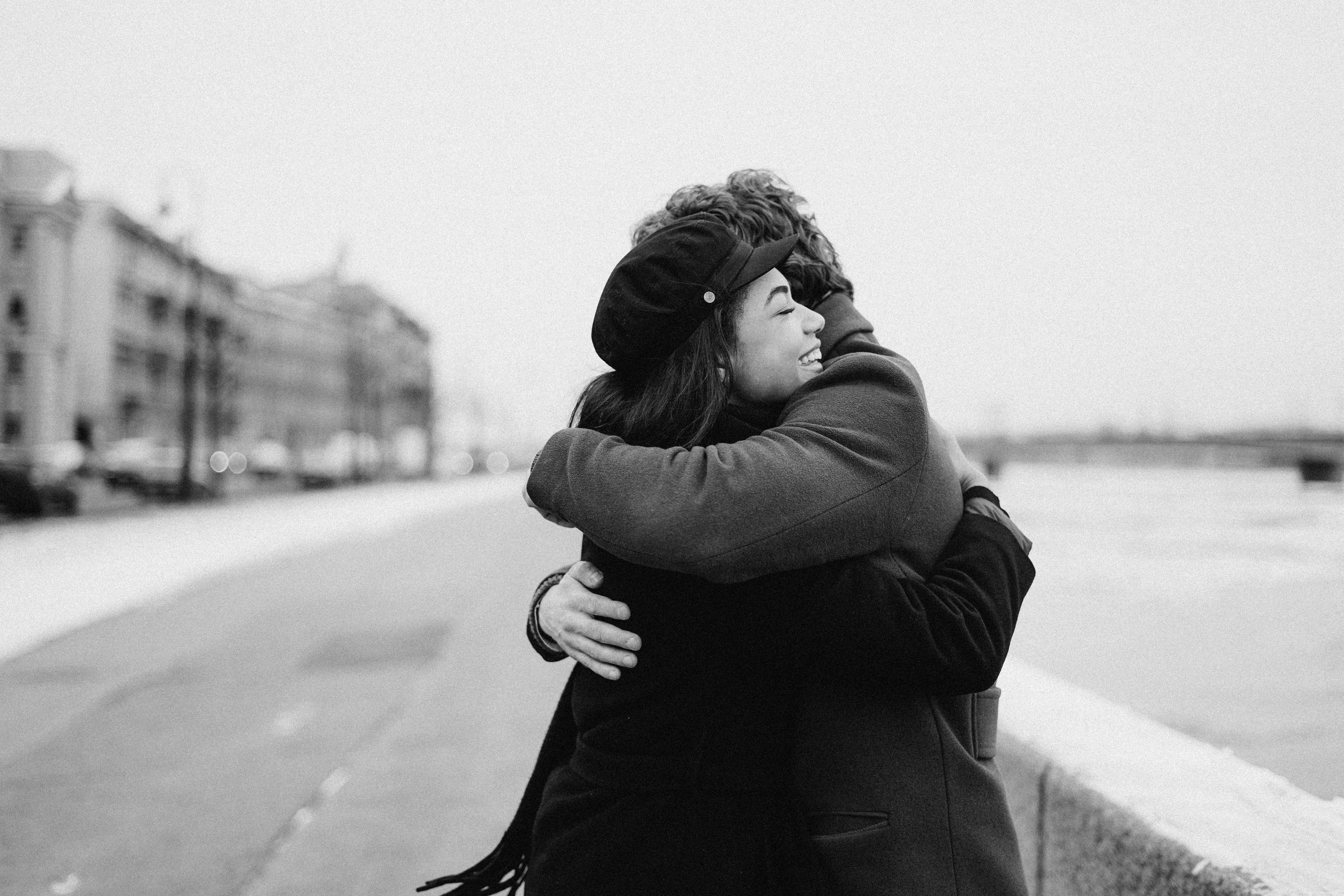 man and woman hugging and smiling