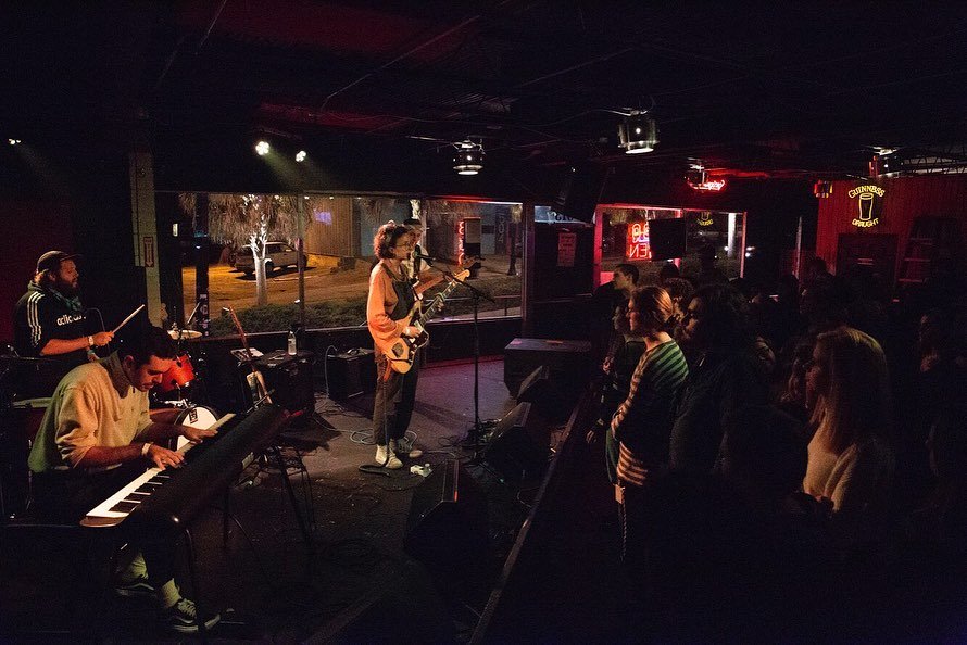 Musicians playing in a dark concert venue