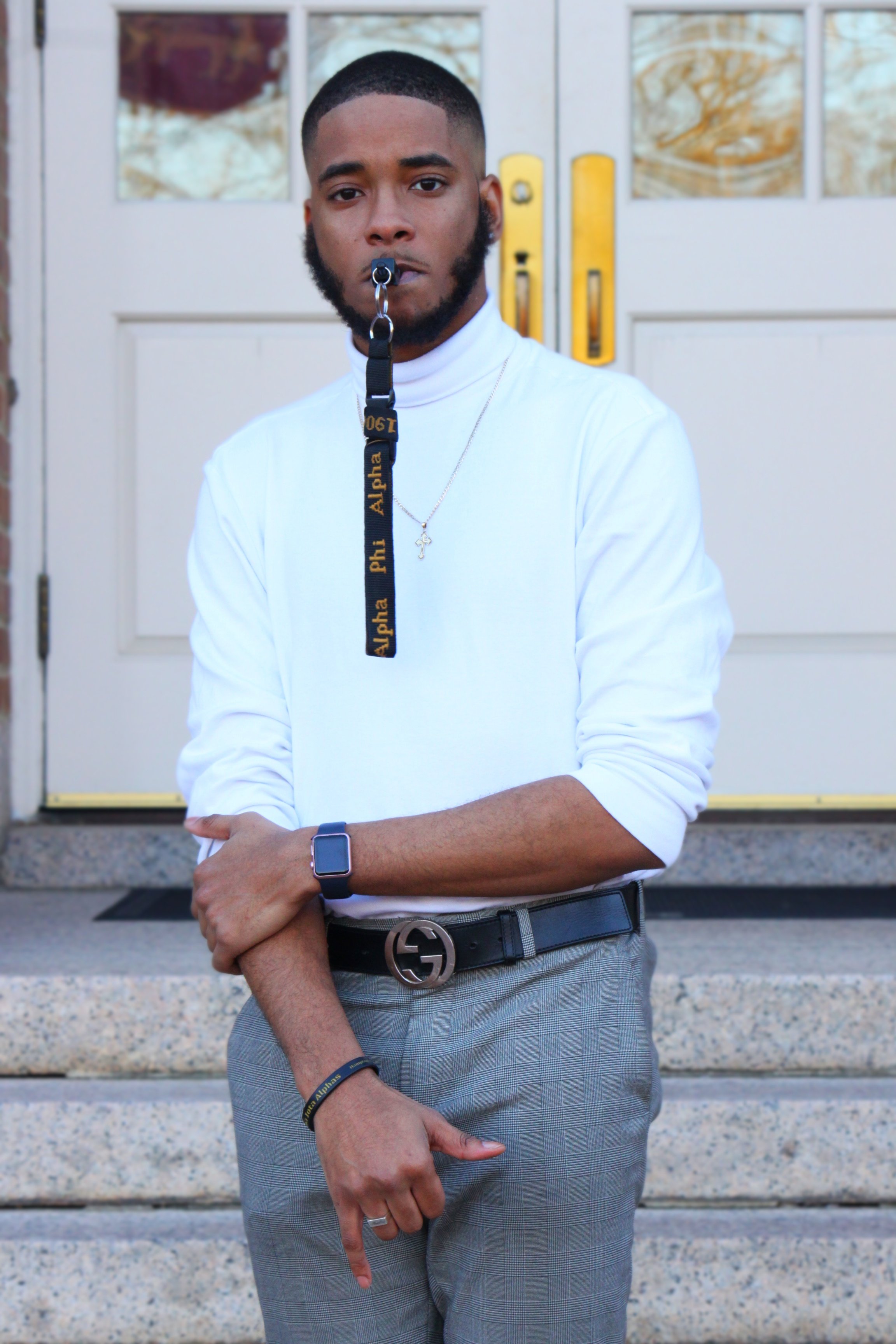 a man in a white shirt with a lanyard hanging