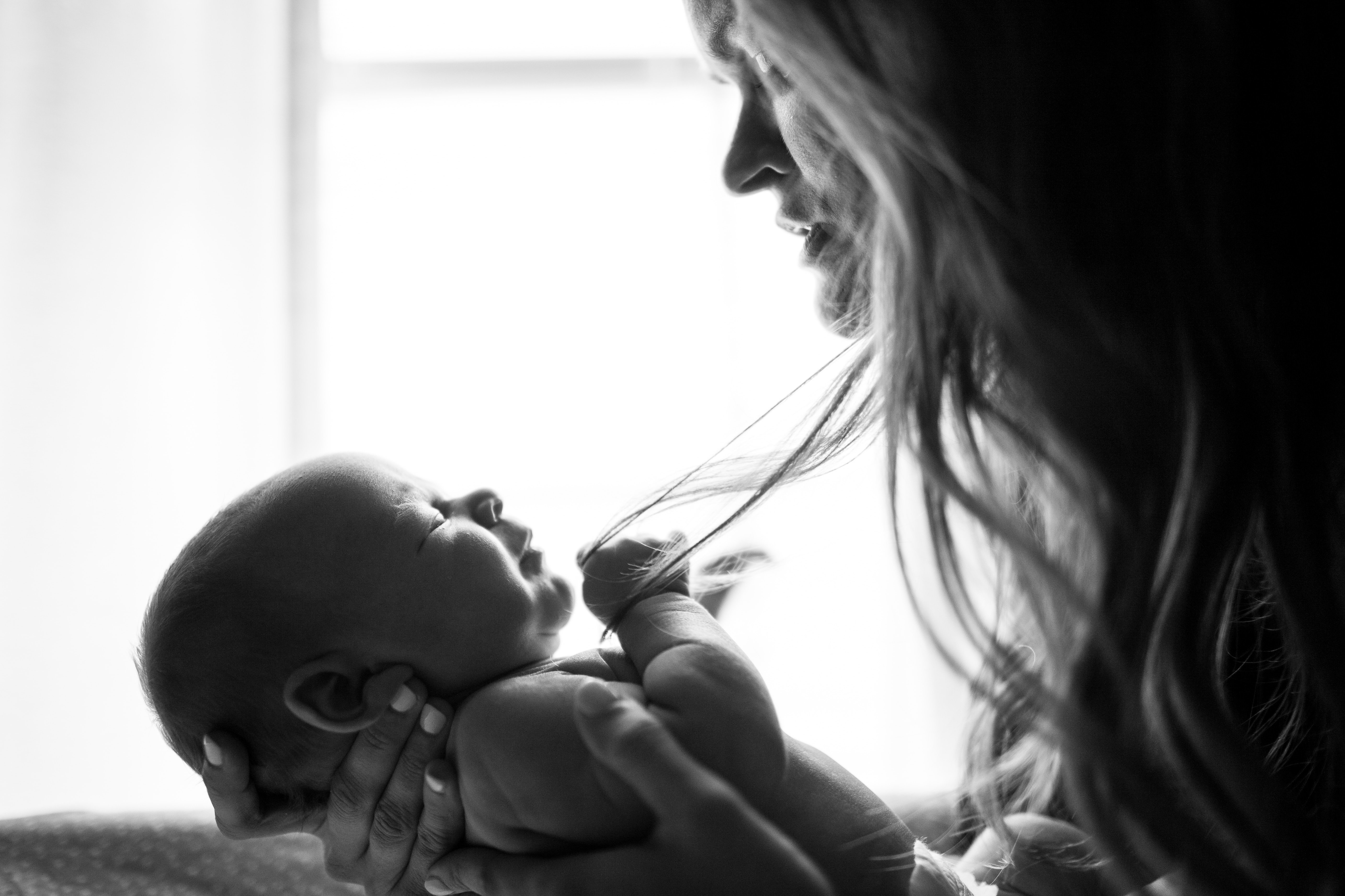 black and white photo of a mother holding a baby