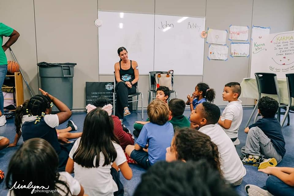 Laura Reiss at the front of a classroom during a Kindness Matters 365 meeting