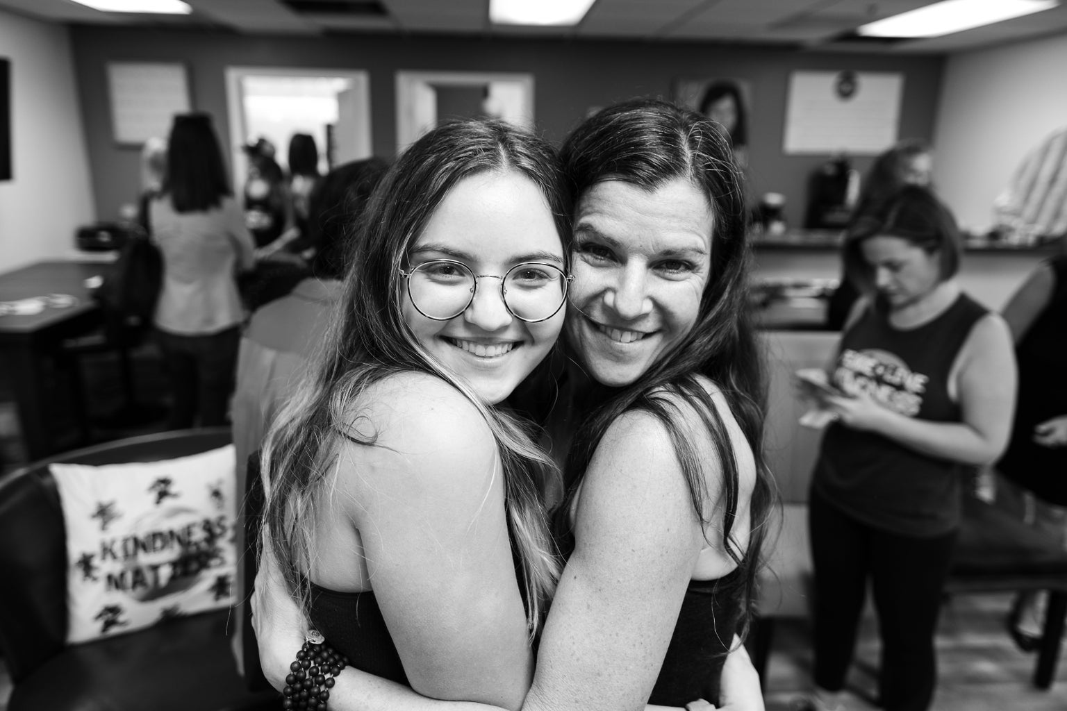 Laura Reiss and Megan Lee hugging at a Nourish Kindness event