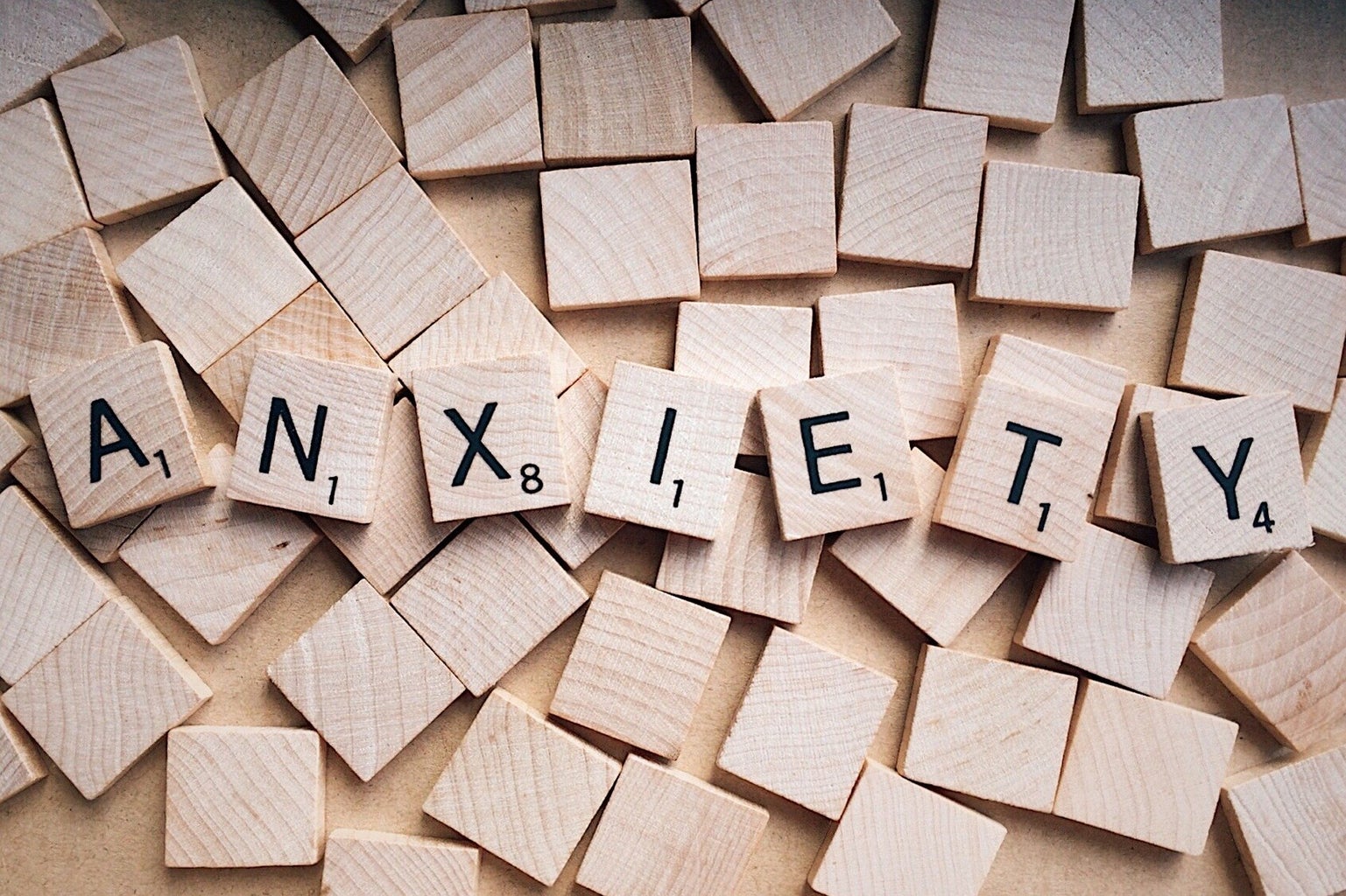 A photo of scrabble words assembled to spell \"anxiety\"