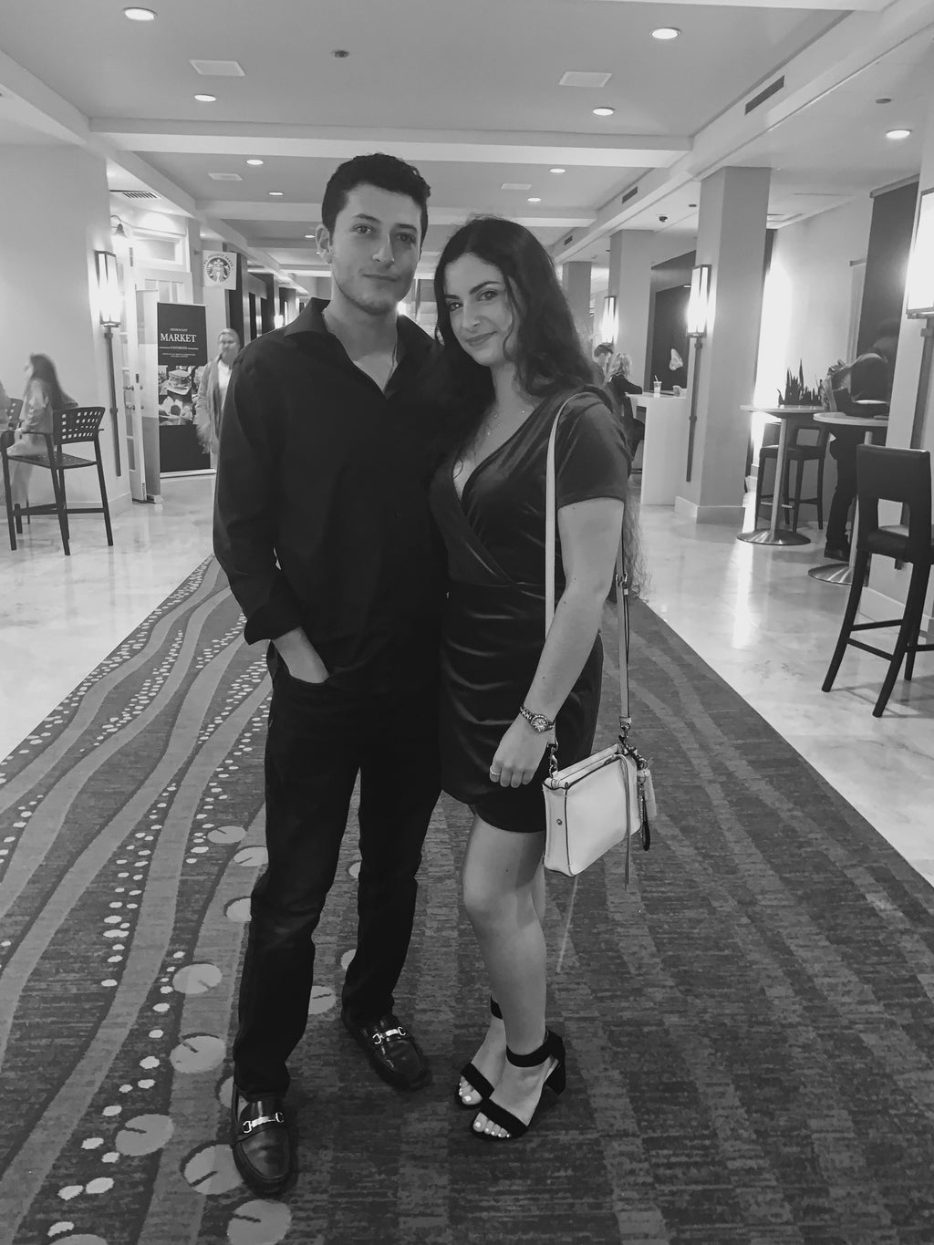 girl and guy posing for picture at hotel