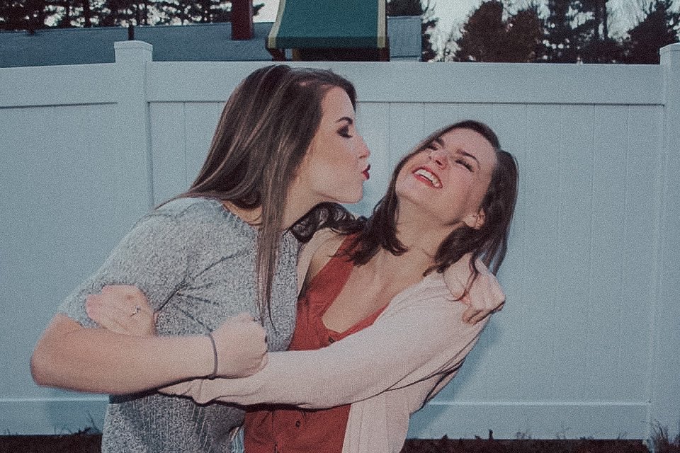 My sister and I in our backyard, taking photos together.