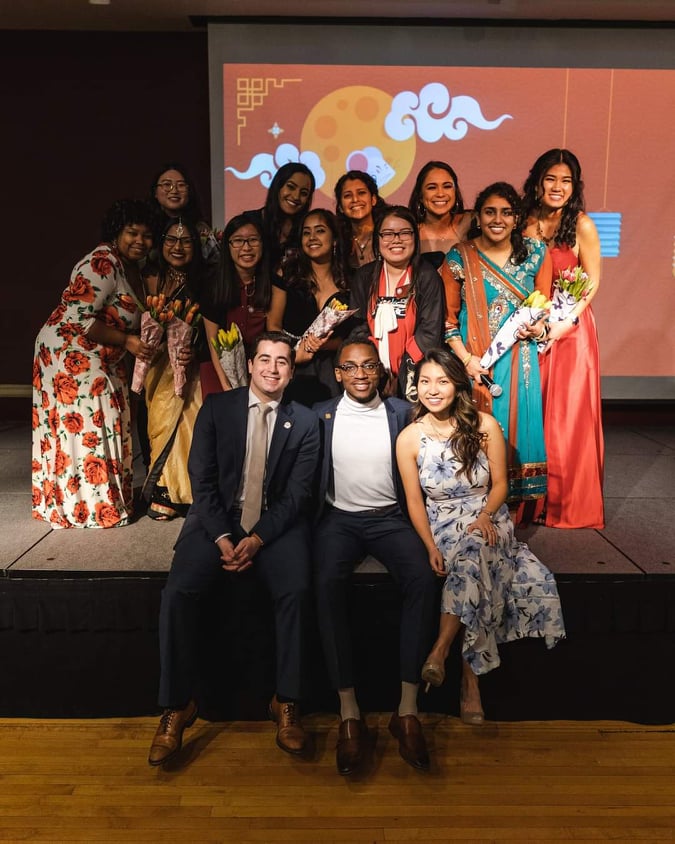 Jully posing with a group of people at an AASU event