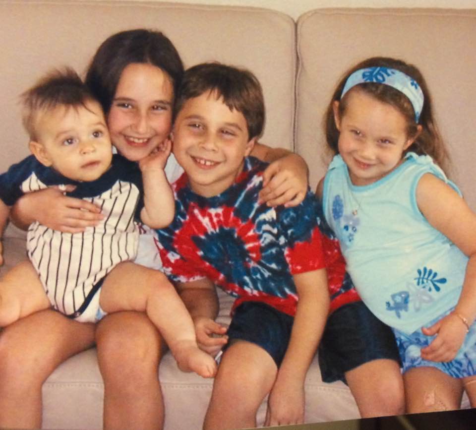 An old photo of four siblings.