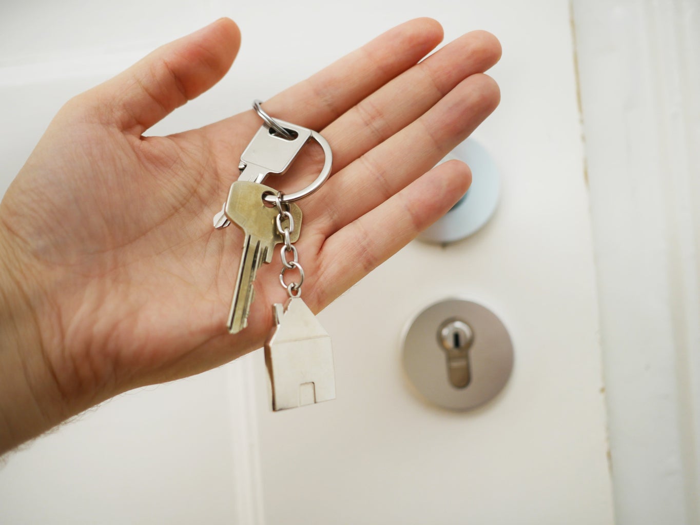 person holding a house key in their hand