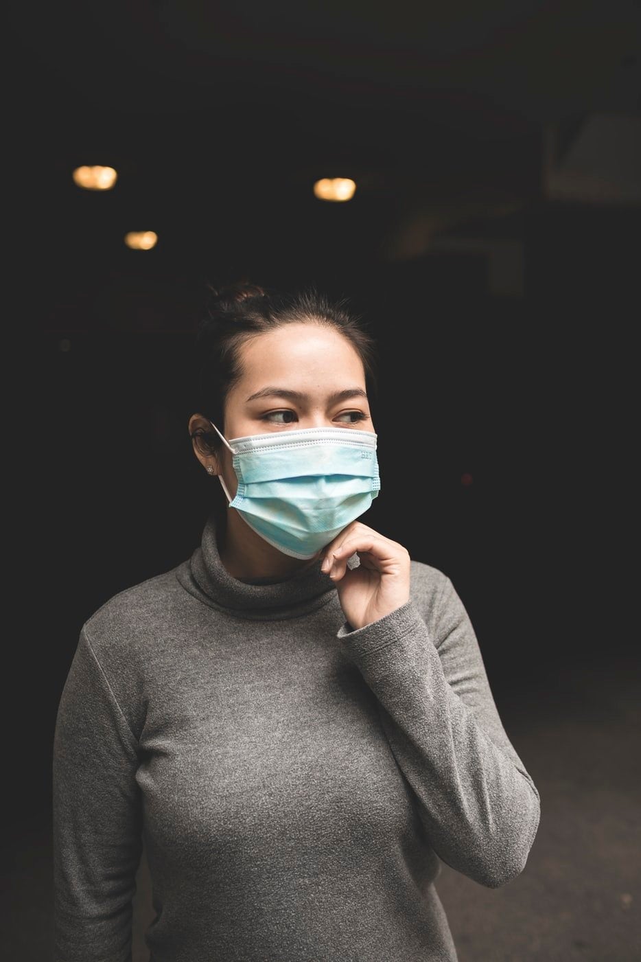 woman wearing teal face mask