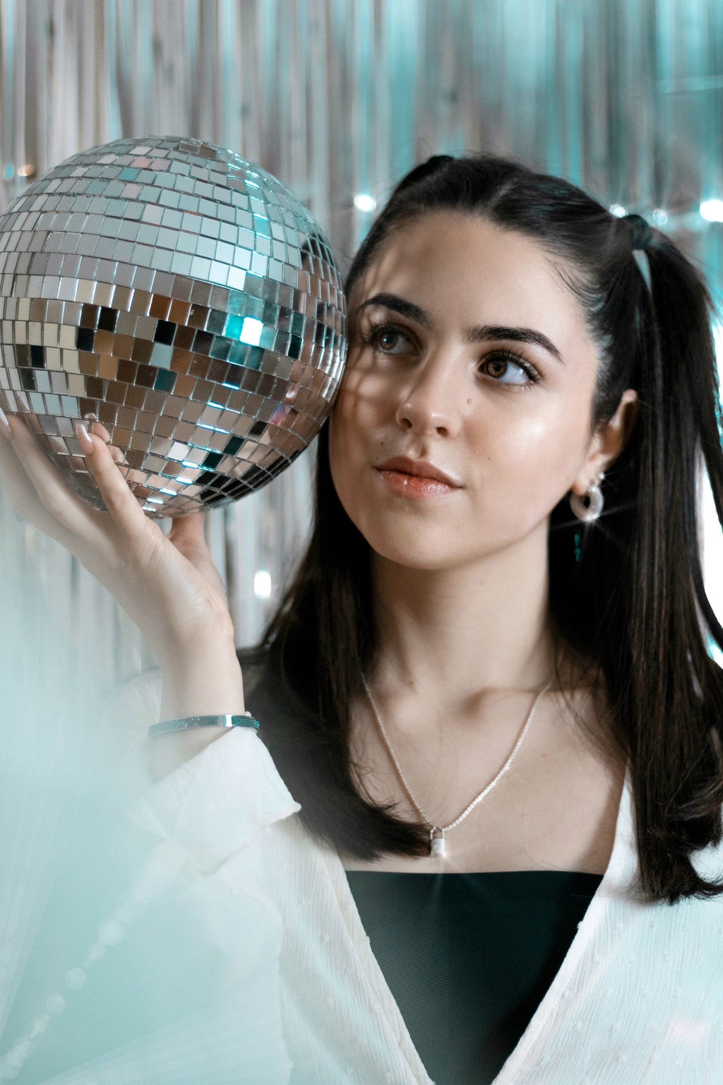 woman holding disco ball for a photoshoot