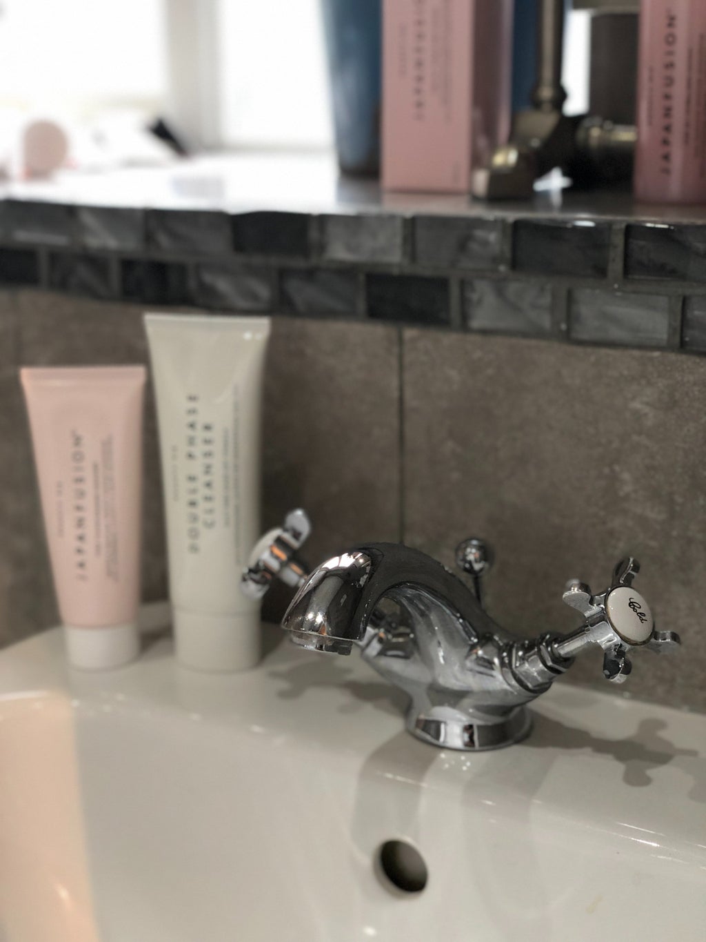 skincare products on sink counter