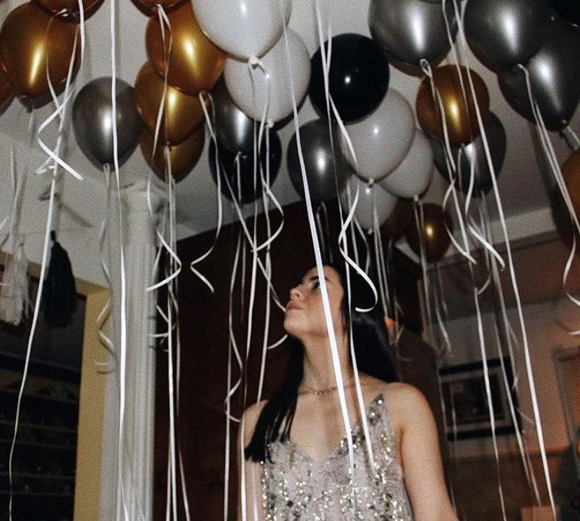 a woman surrounded by balloons