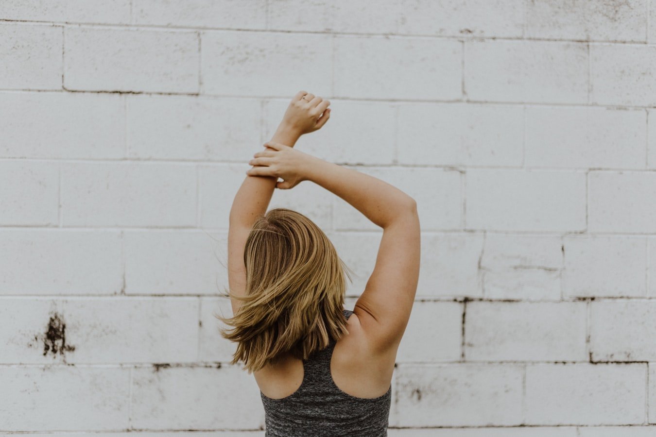 woman dancing in front of white wall