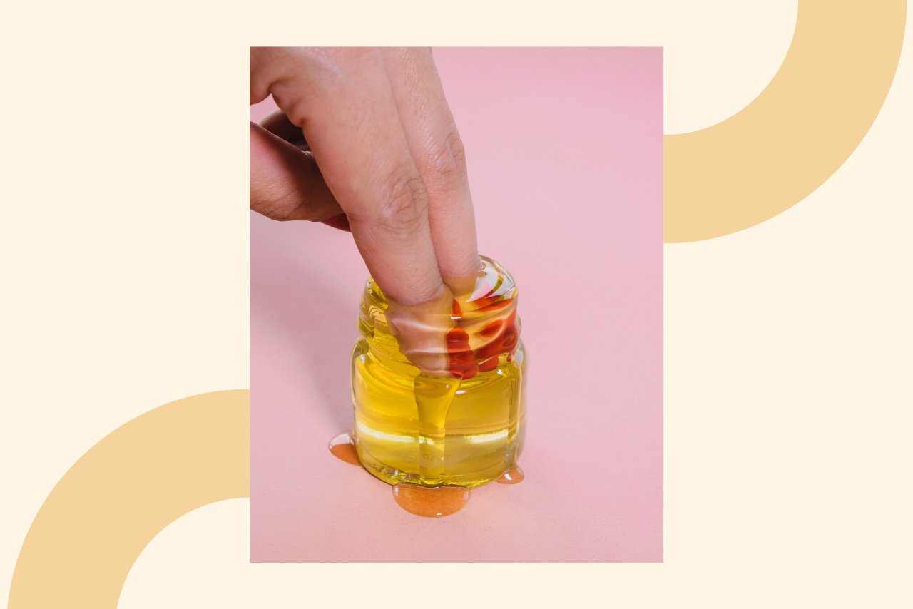 fingers in jar of oil