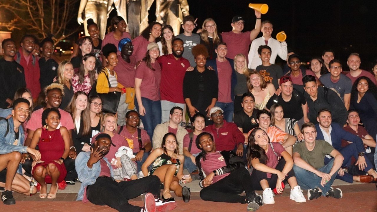 Students in a large crowd smiling for a photo