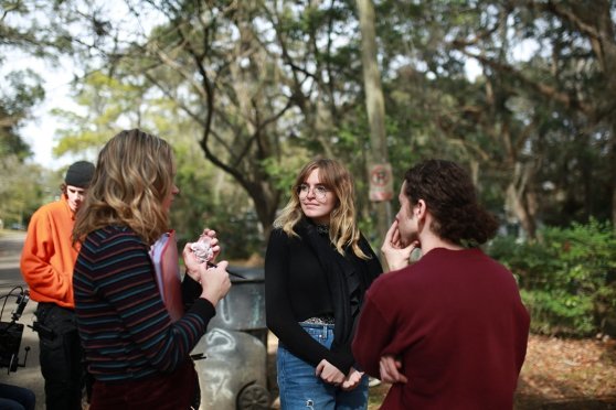 Summer standing in a circle while directing