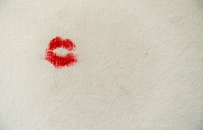 Red lip stain on white wall