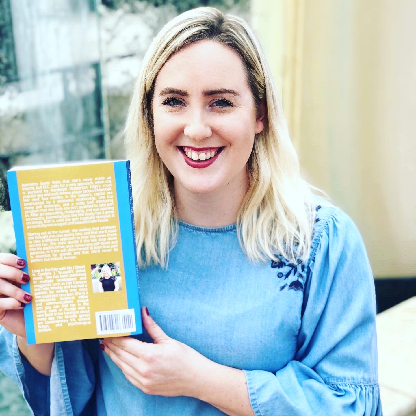 Caroline Trussell holding her novel