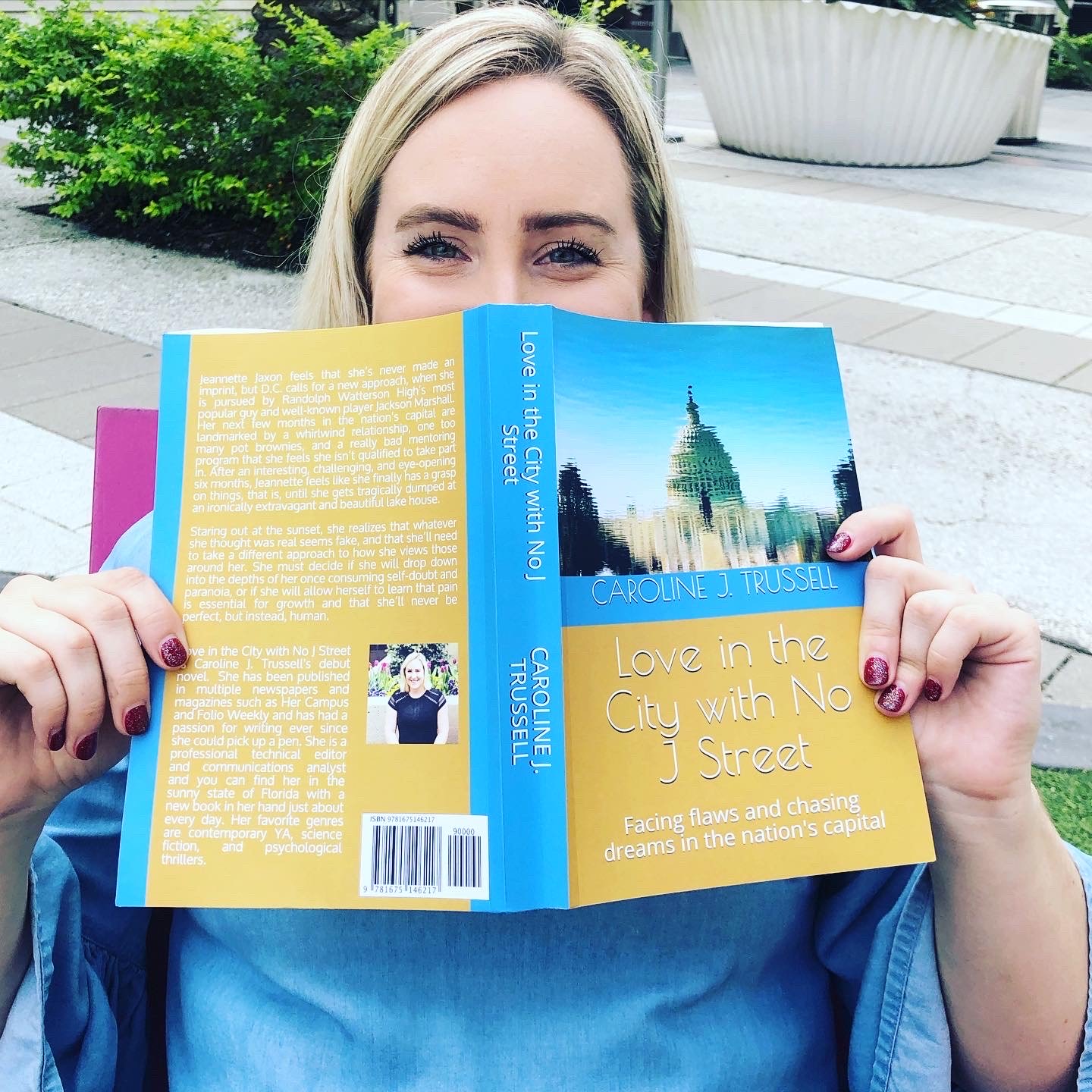 Caroline Trussell holding her novel