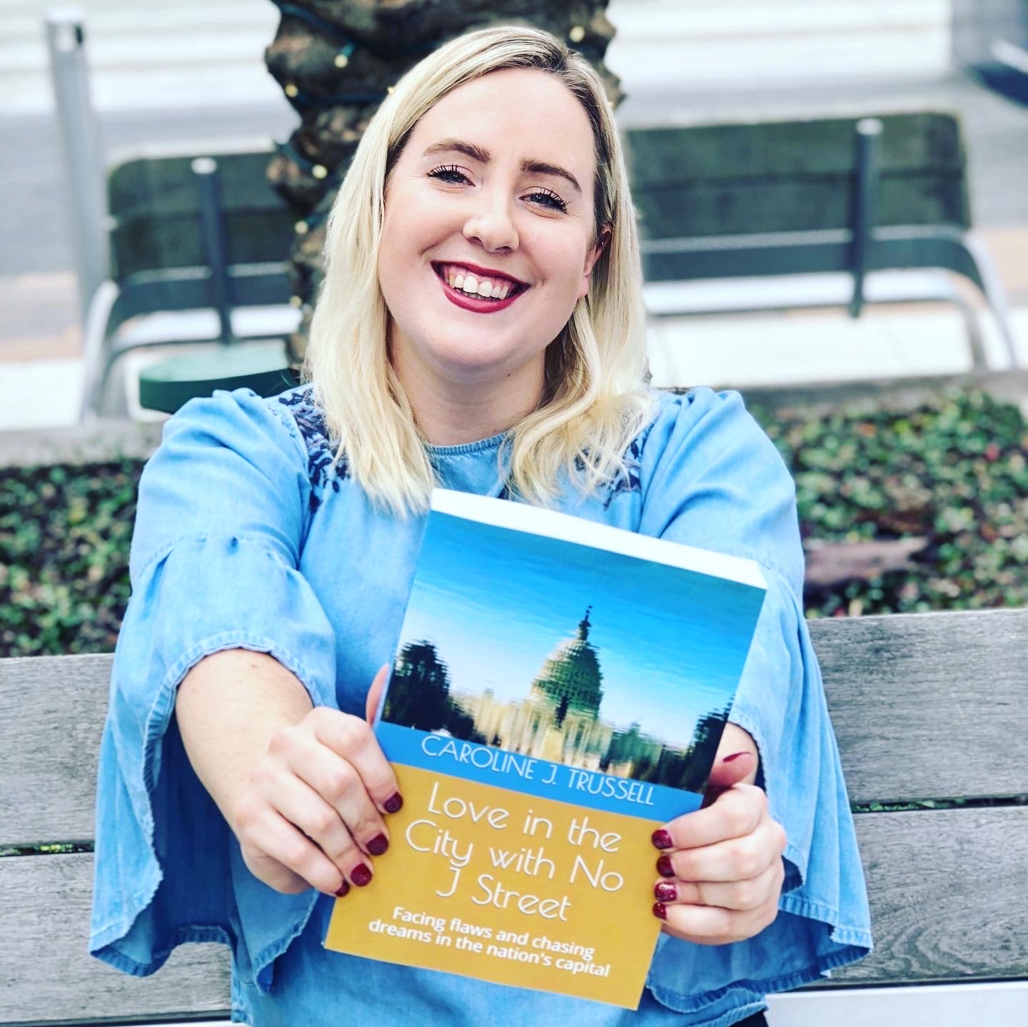 Caroline Trussell holding her novel