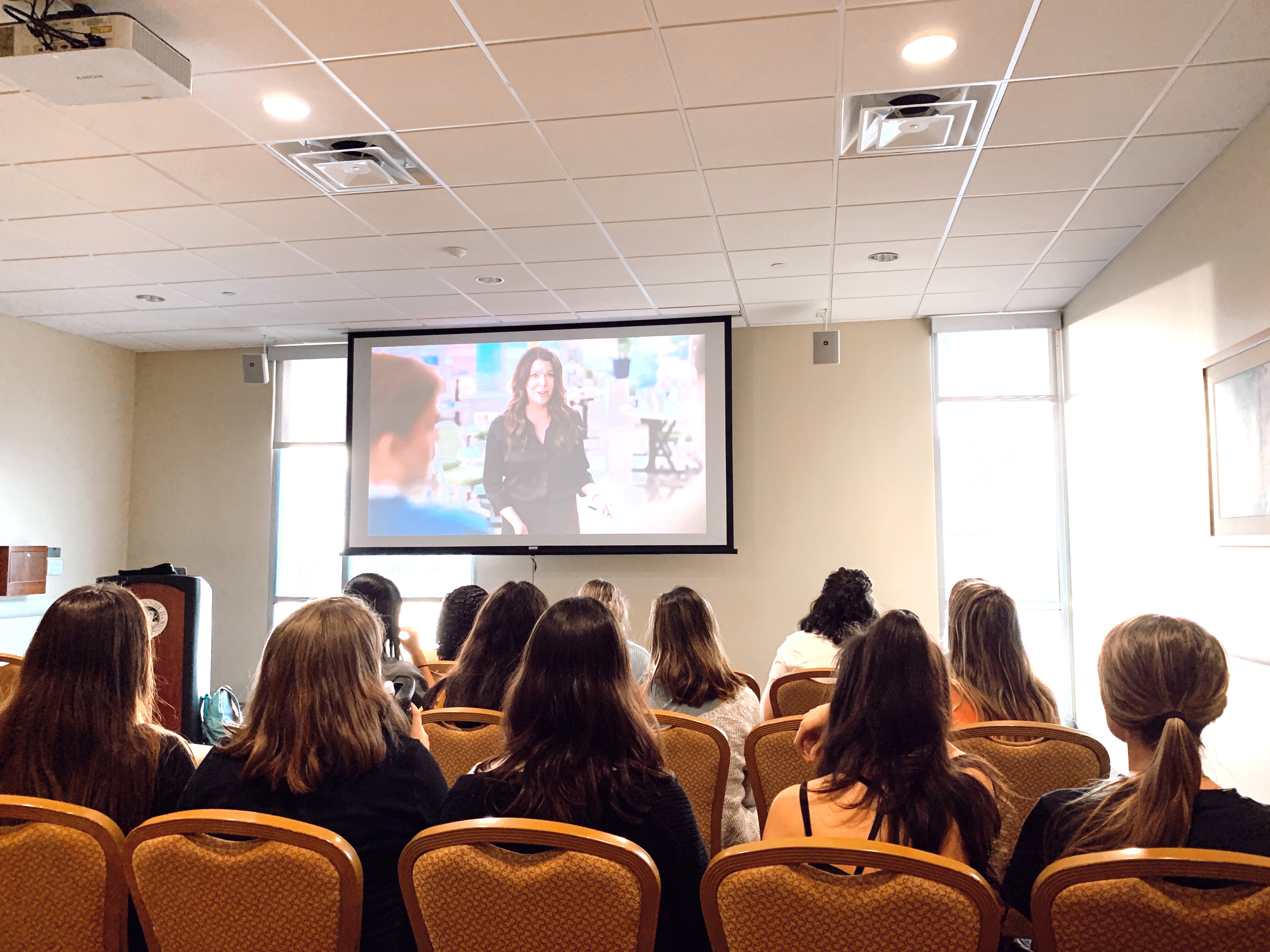 Back of team members watching tv