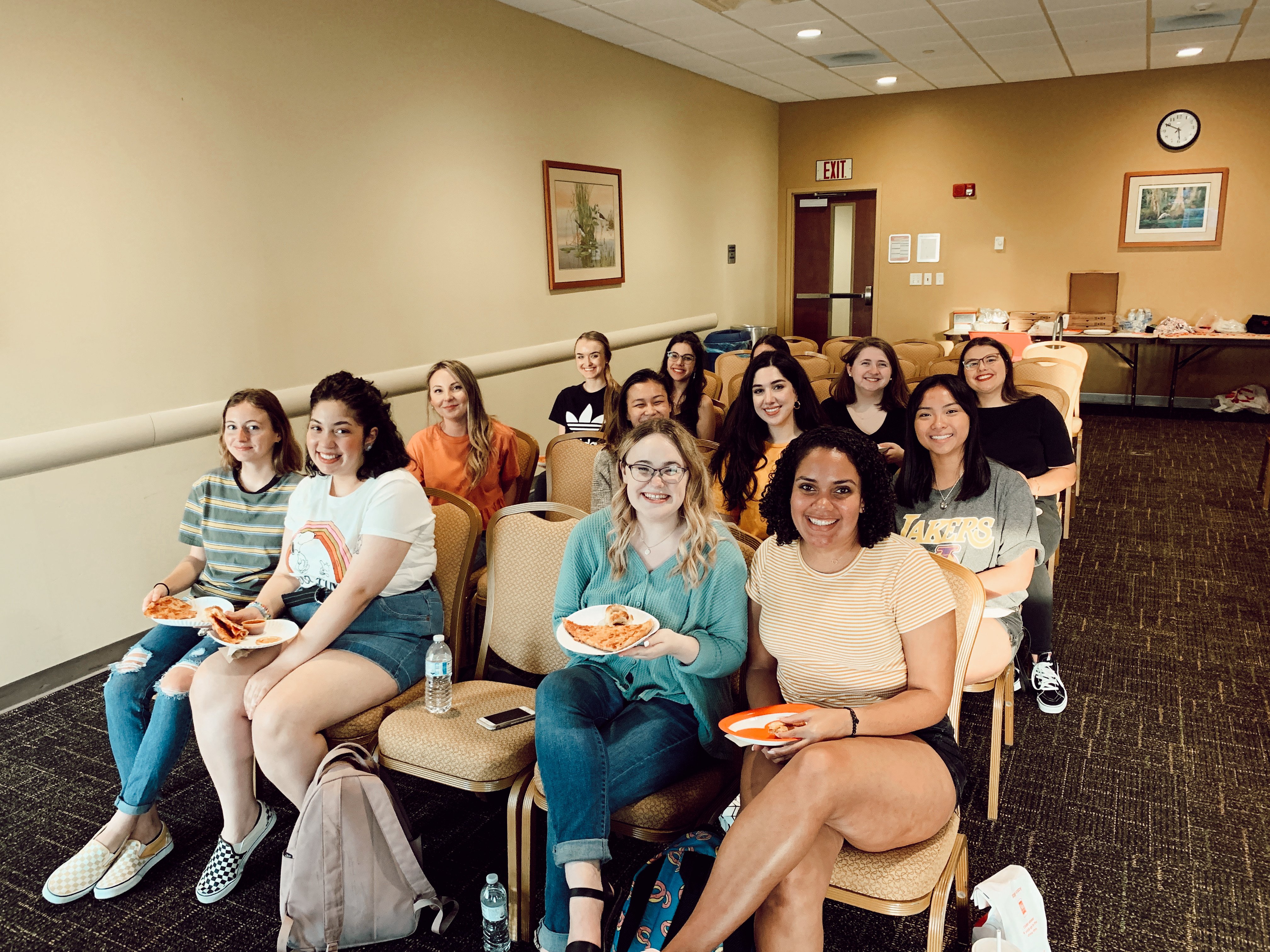 Team members watching tv and smiling