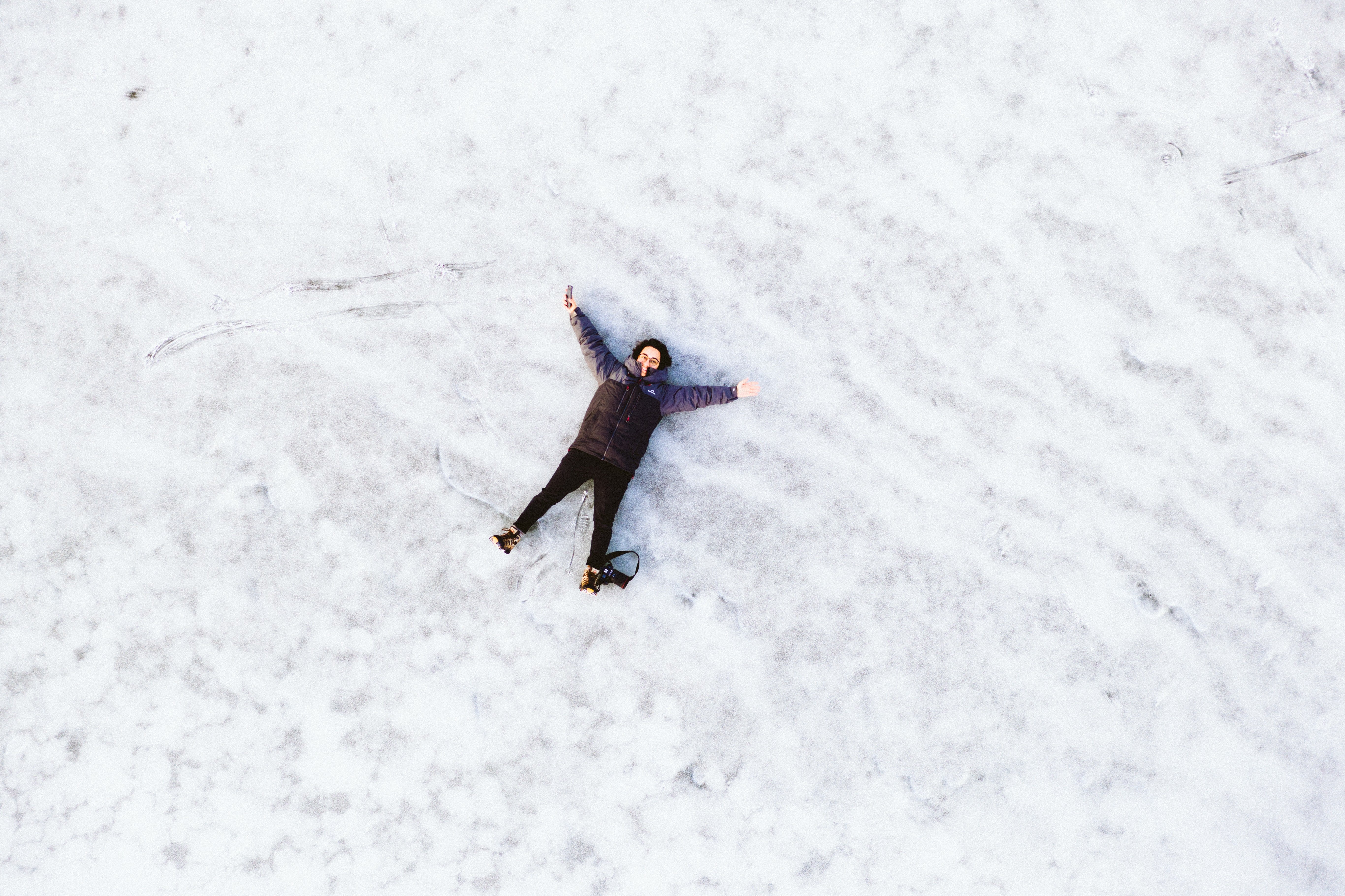 person laying in the snow