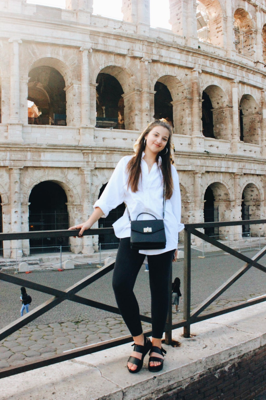 woman standing at colosseum