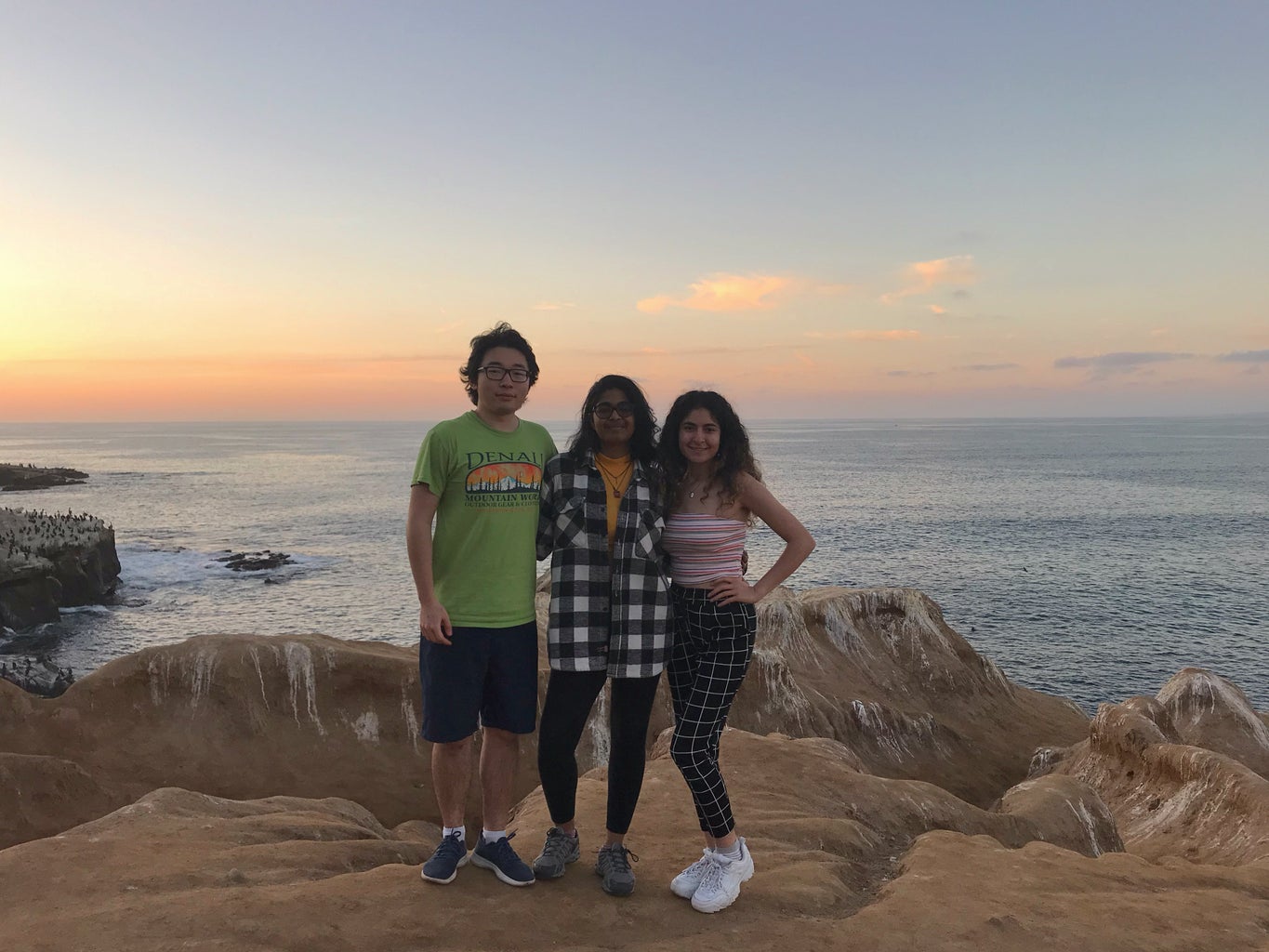 three friends standing together at La Jolla Cove