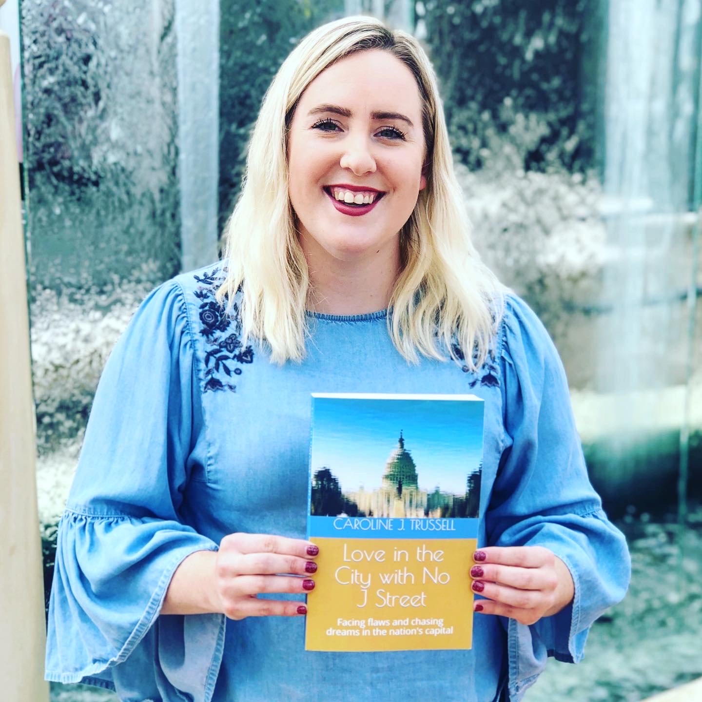 caroline trussell holding her novel