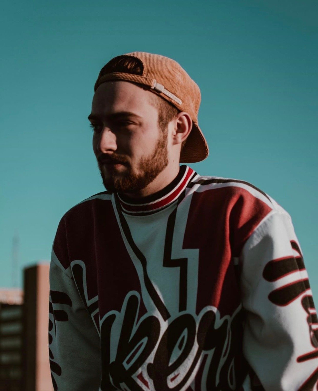 Noah Floersch with hat on and varsity jacket