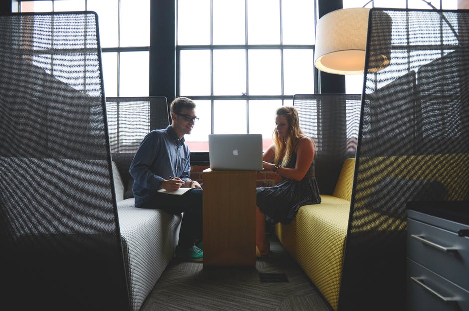 two people working on laptop together at work job