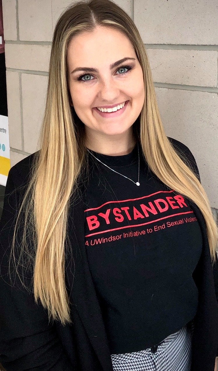 smiling woman in \"bystander\" t-shirt