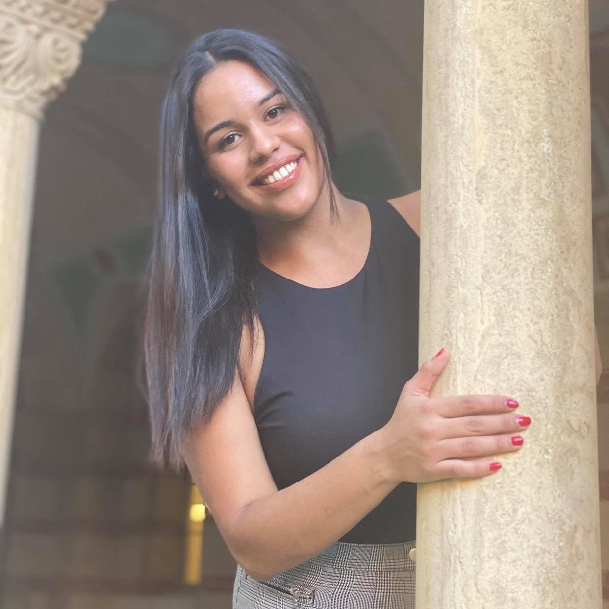 woman standing next to pillar