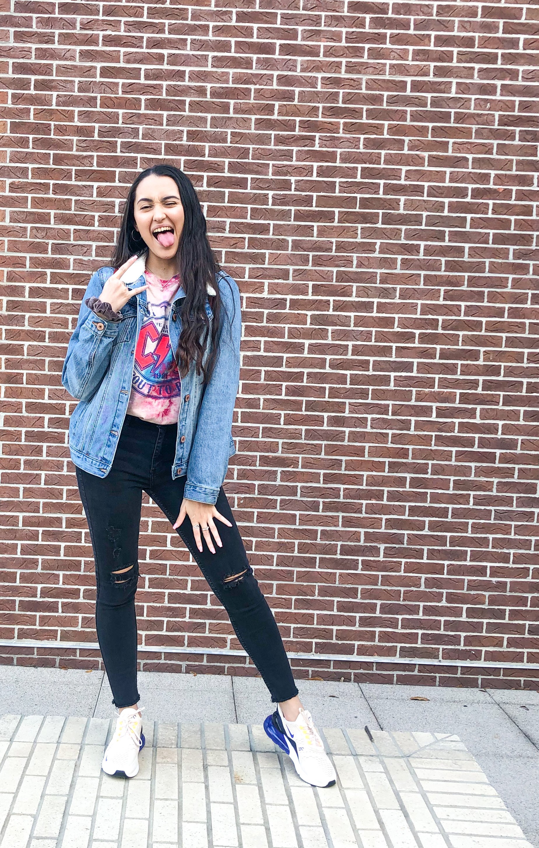 Me in an outfit against a brick wall