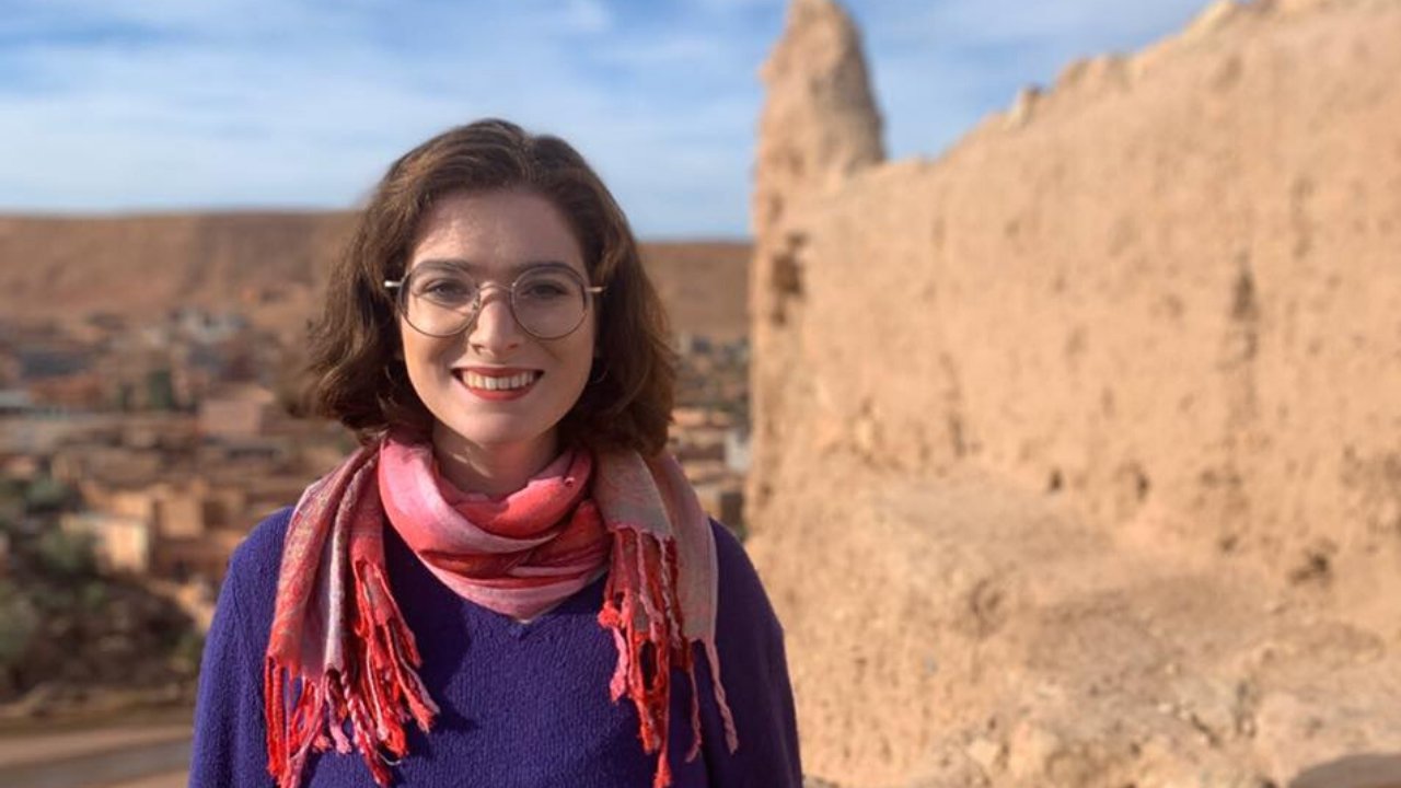 Woman in pink scarf in a desert