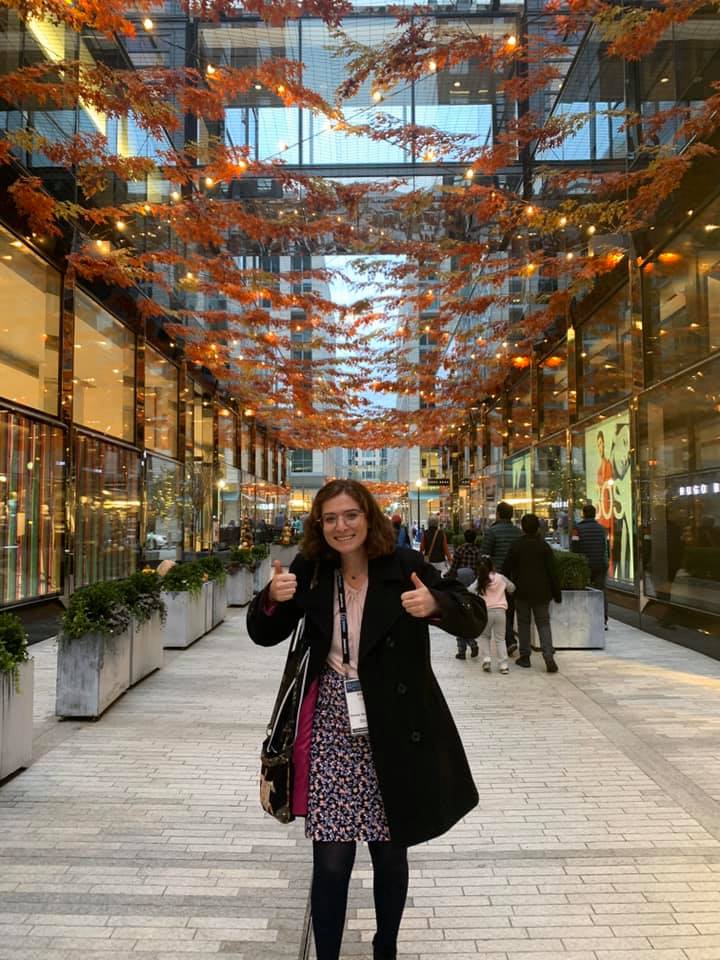 Woman in black jacket giving thumbs up