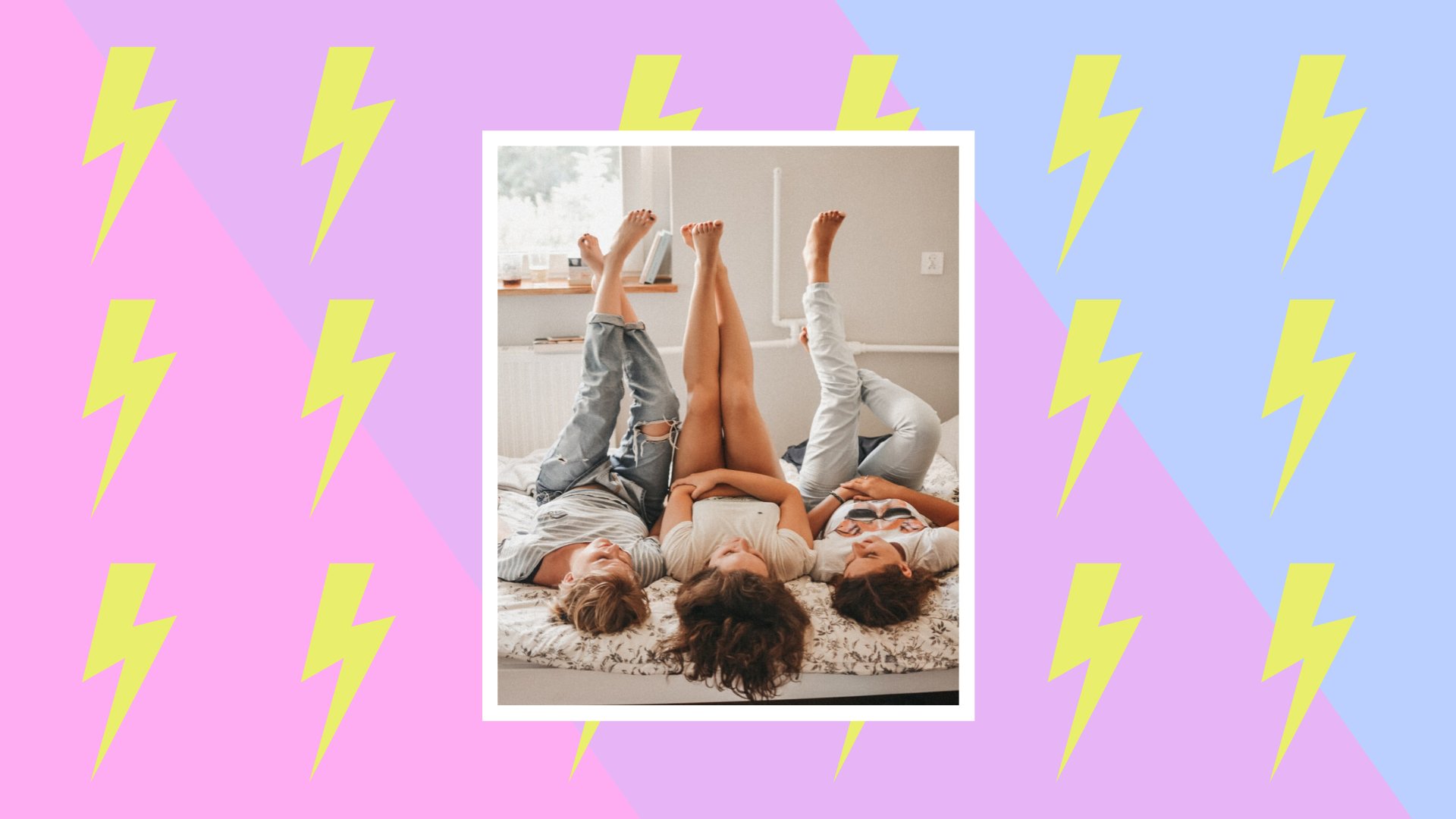 three women lay next to each other on a bed with their feet up in the air.