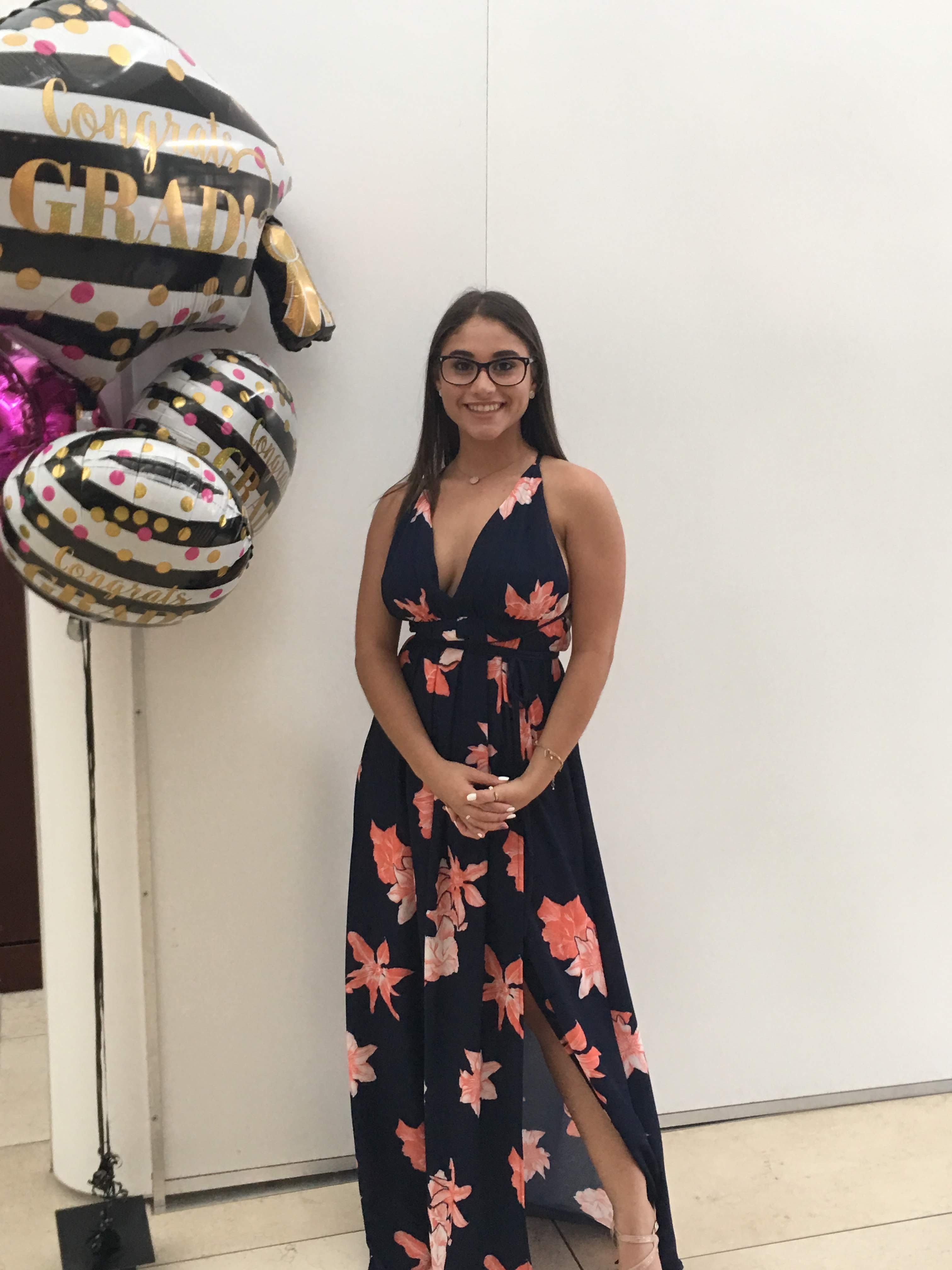 patty ortiz standing beside balloons