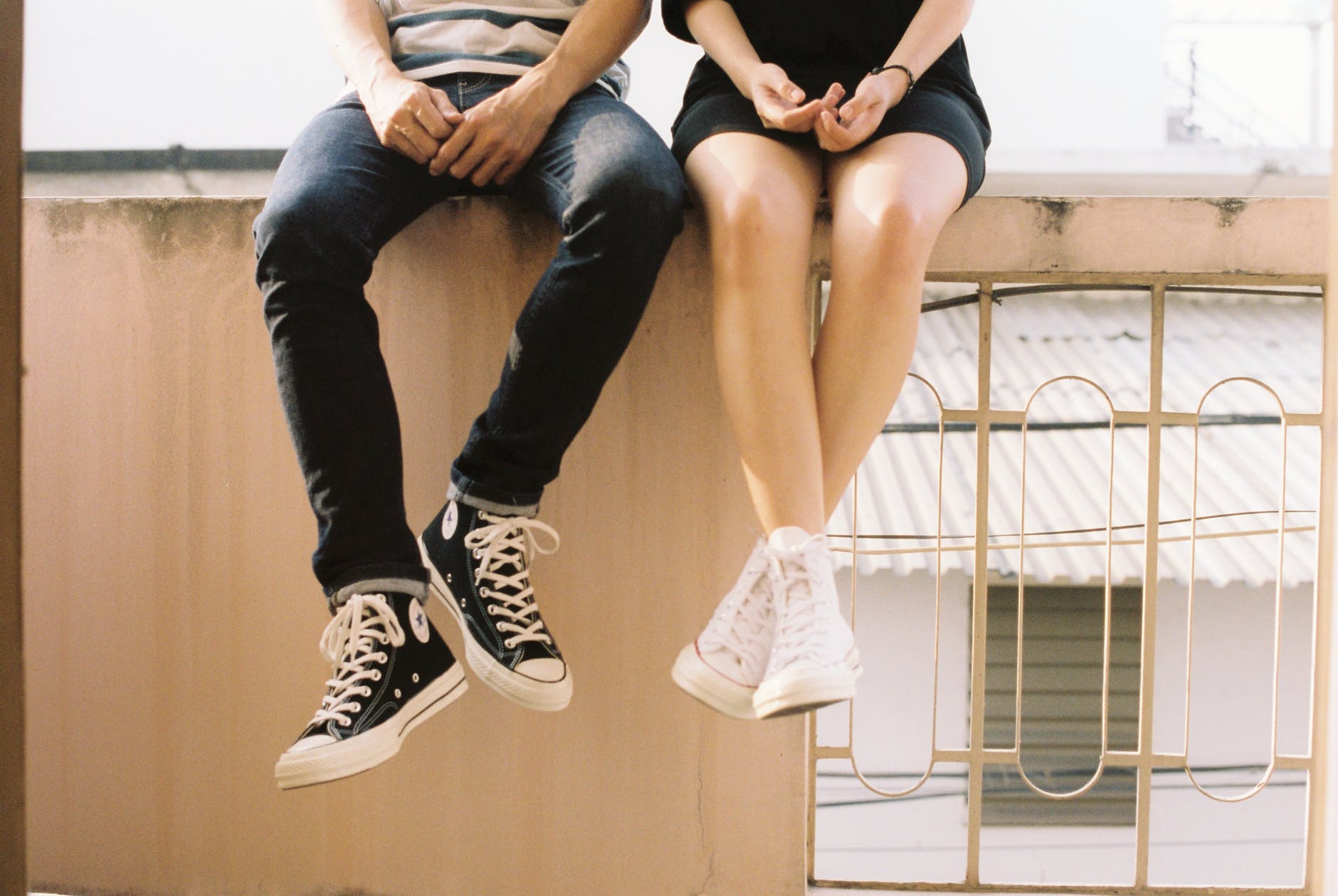 couple sitting on wall