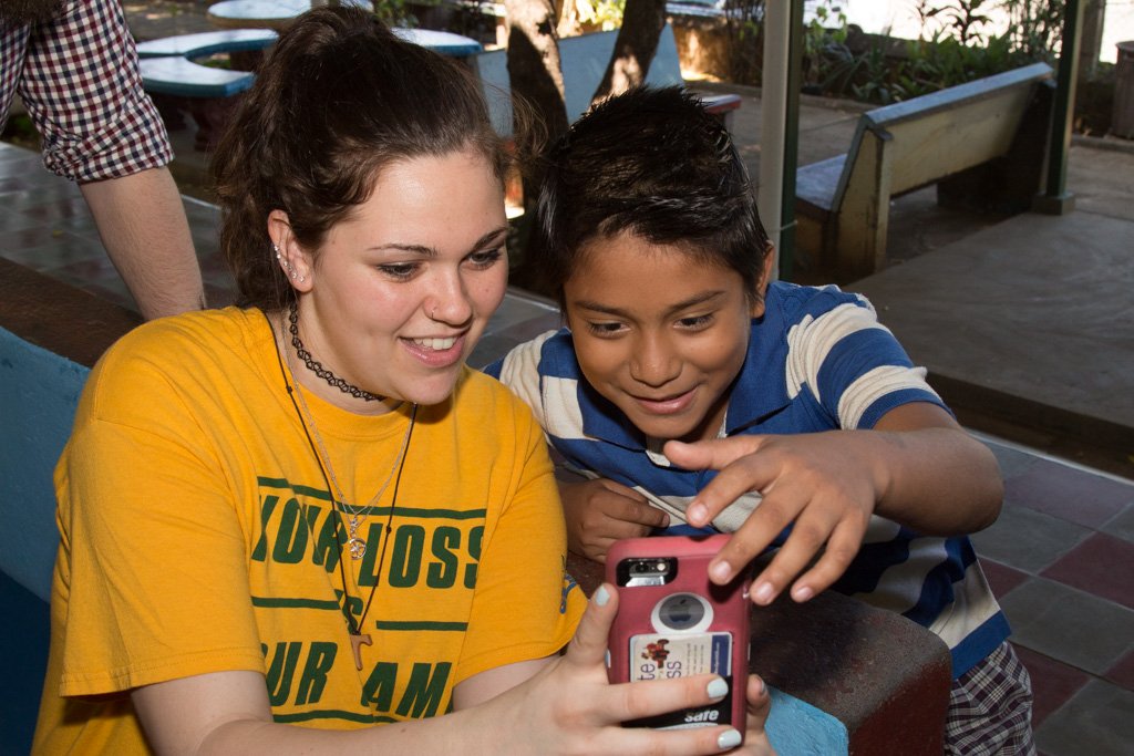 girl and boy looking at a phone