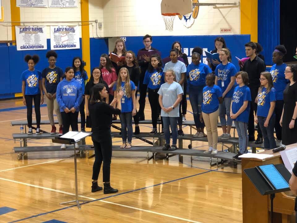 Girl standing in front of group of children