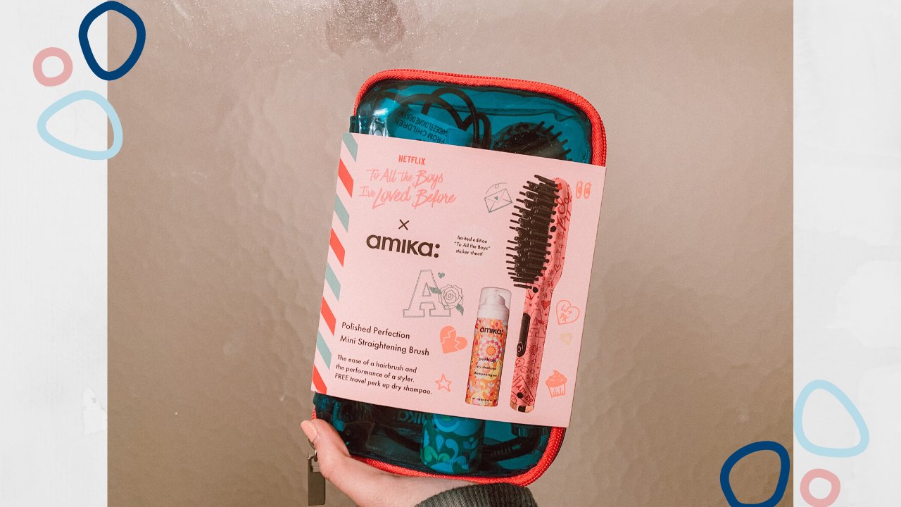 me holding an Amika haircare package that was gifted.